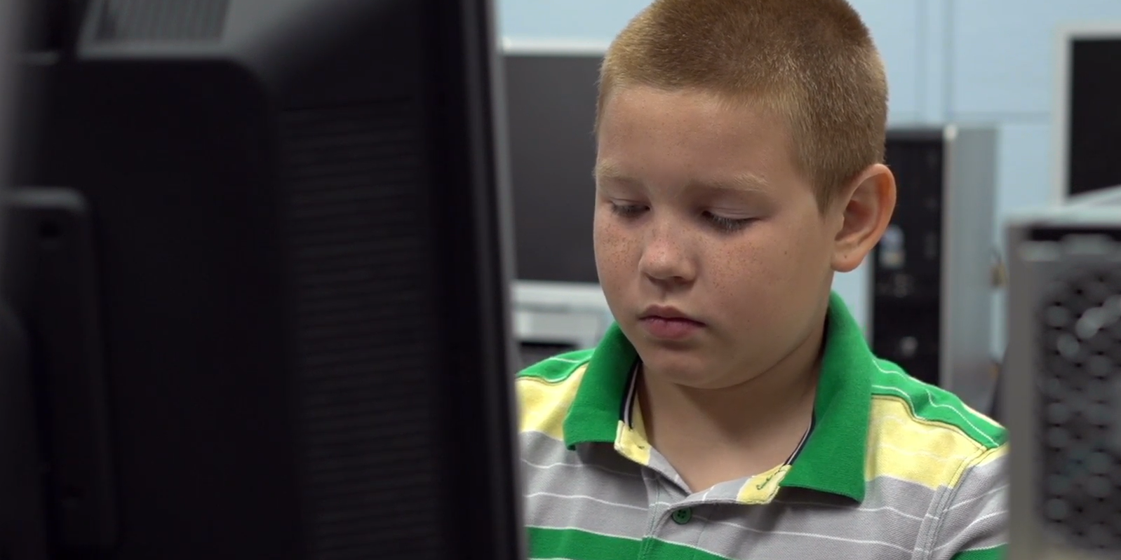 Child sitting at computer